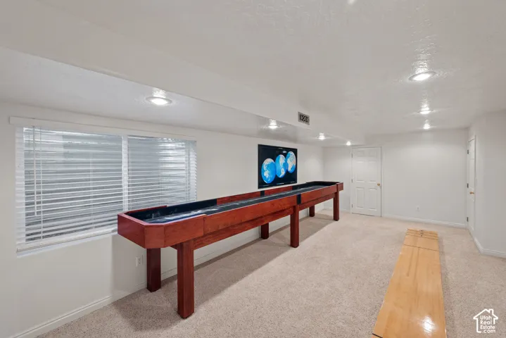Recessed lighting, light-toned carpeting, white walls, and white trim