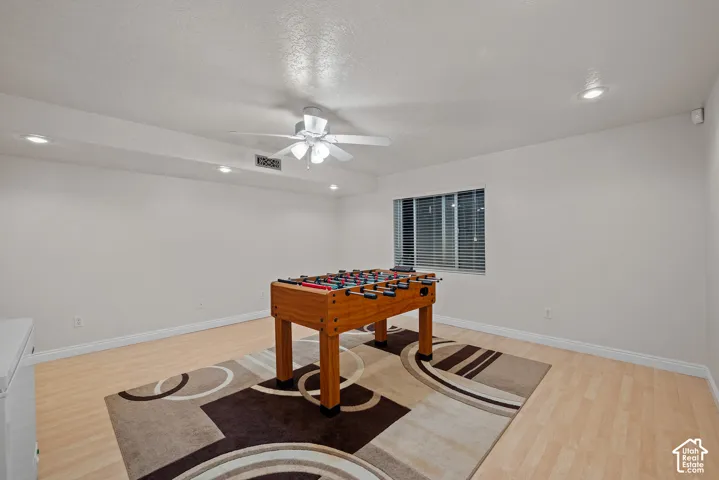 Recessed lighting, ceiling fan, wood-finish flooring, and window with blinds