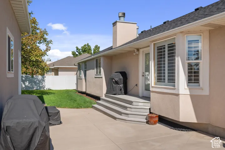 Exterior patio with multi-level steps, a stucco finish, and a bay window