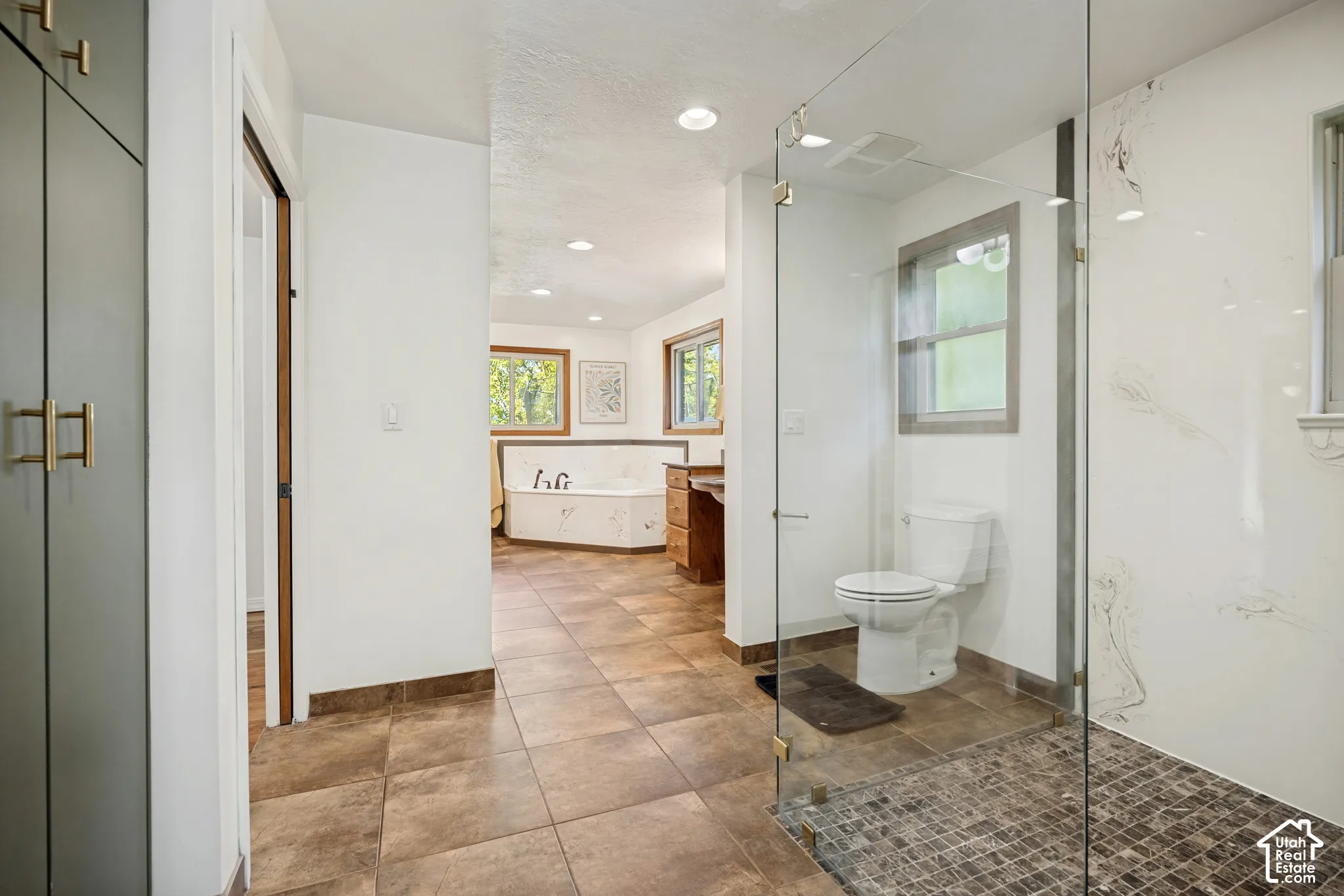 Primary bathroom with shower, freestanding tub, and dual vanities