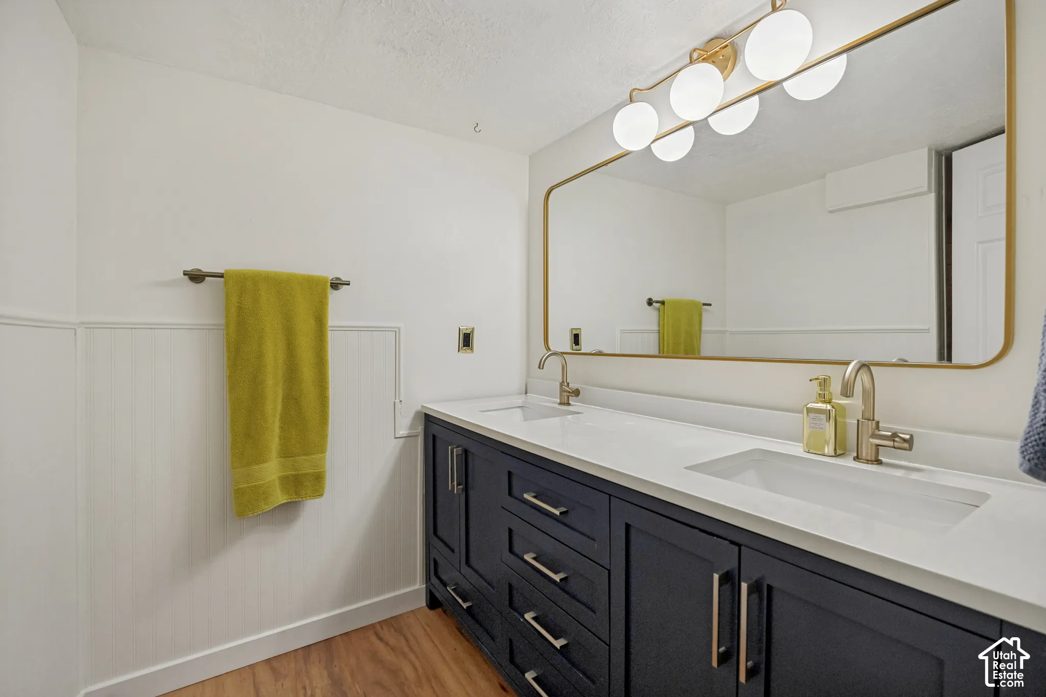 Full basement bathroom with dual vanities
