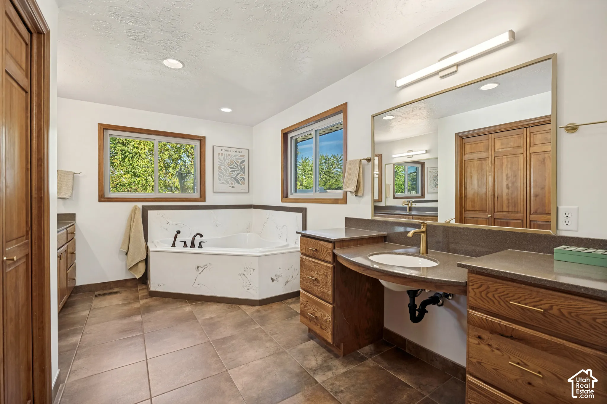 Primary bathroom with shower, freestanding tub, and dual vanities