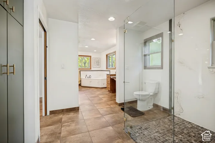 Primary bathroom with shower, freestanding tub, and dual vanities