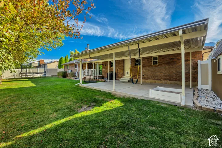 Spacious fenced backyard with large covered patio