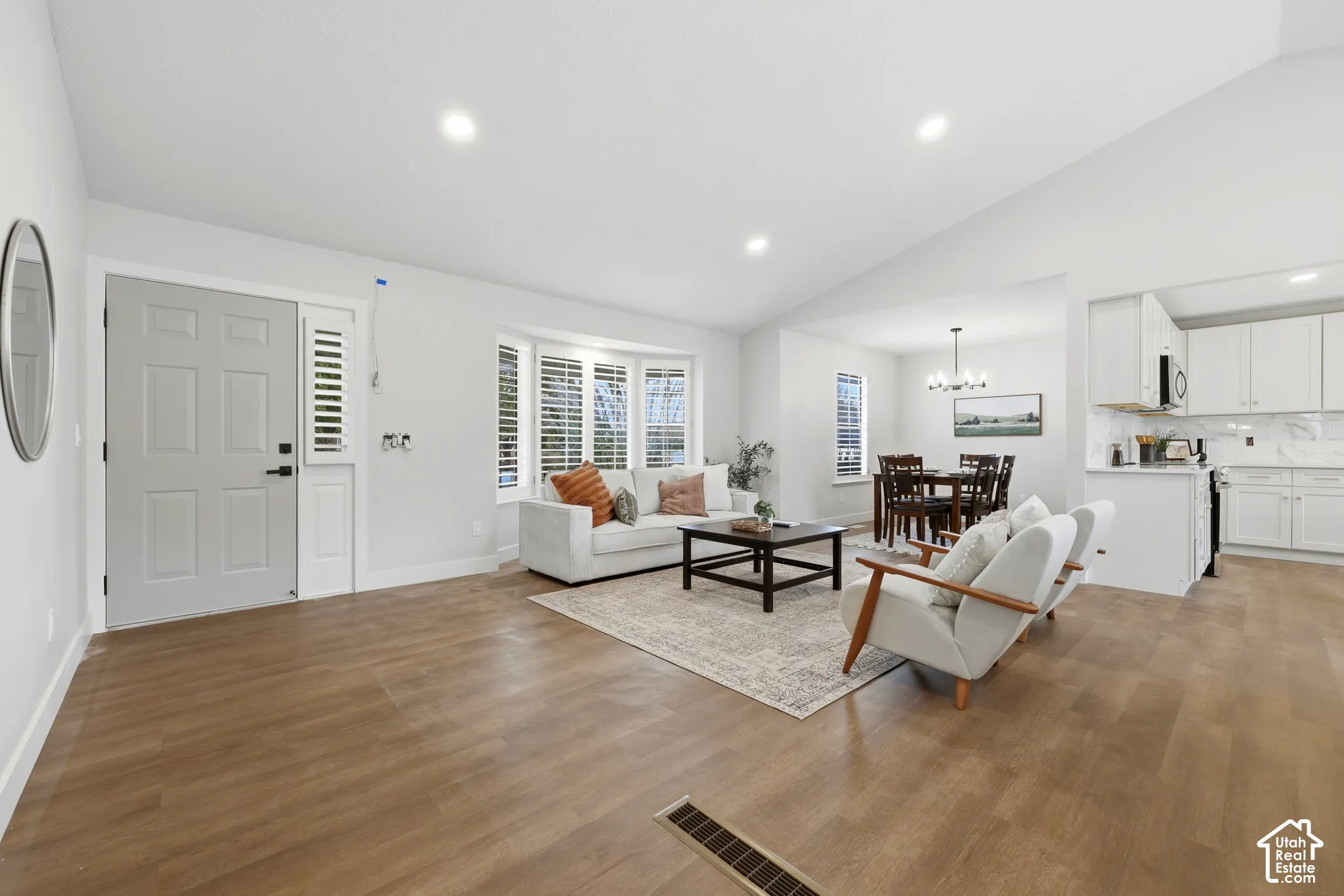 Wood-finish flooring throughout, recessed lighting, and a vaulted ceiling