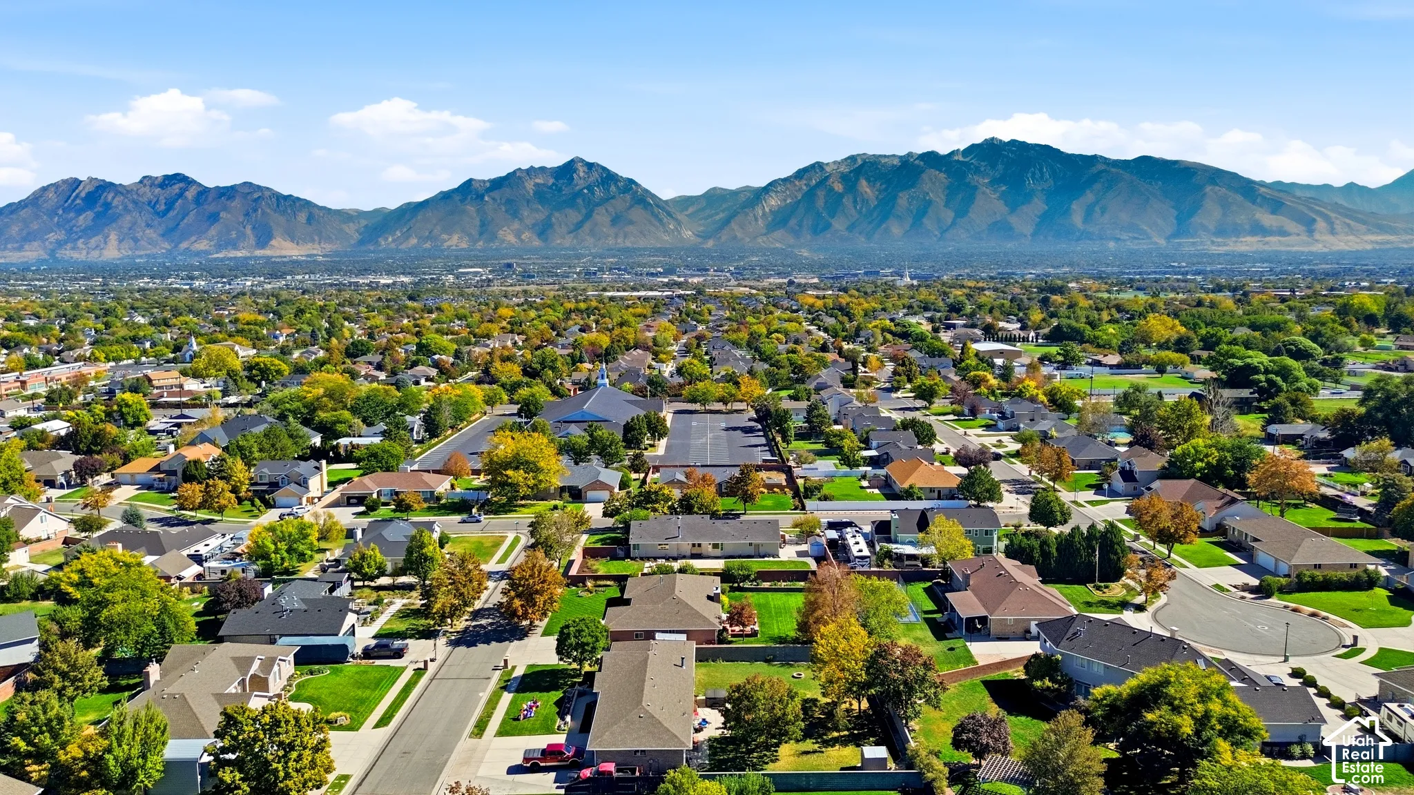 Residential neighborhood with an expansive mountain backdrop and mature trees