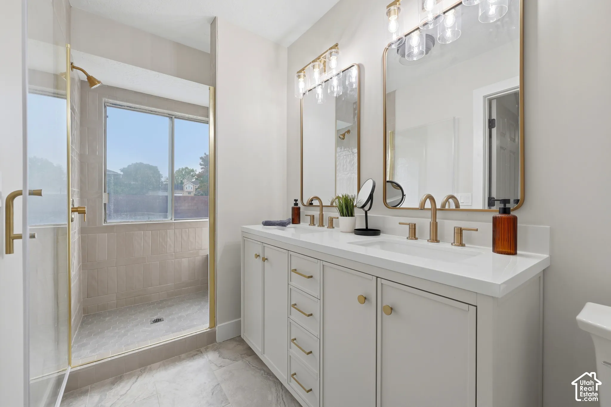 Dual vanity with integrated sinks and gold-finish hardware
