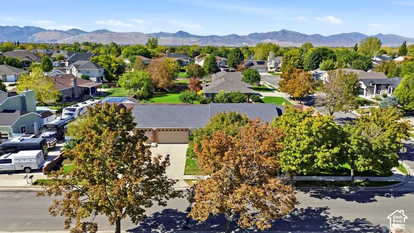 Expansive paved driveway leading to a two-car garage