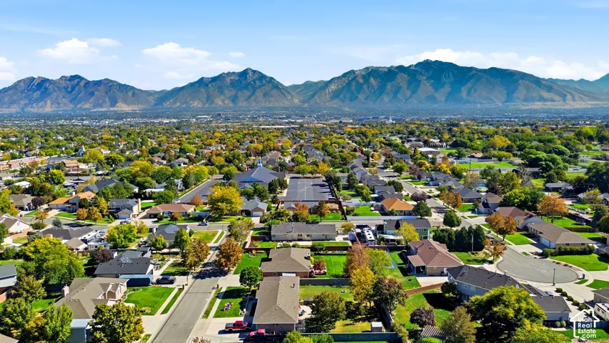 Residential neighborhood with an expansive mountain backdrop and mature trees