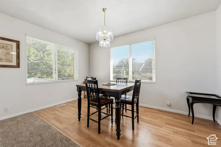 Recessed lighting, wood-finish flooring, and white walls create a bright interior