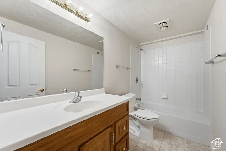 Basement bathroom with wood-finished vanity and tub/shower combo