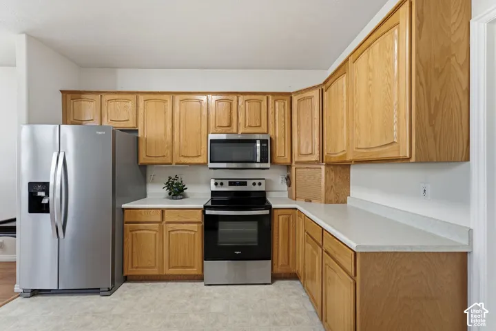 Kitchen featuring wood cabinets and light-toned countertops