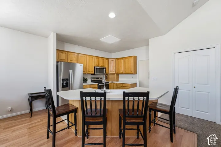 Open-concept kitchen and dining area featuring stainless steel appliances
