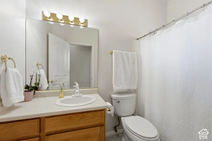 Hall bathroom featuring a wood-finished vanity