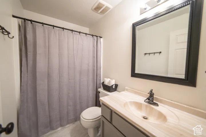Vanity with integrated sink, framed mirror, and mounted light fixture