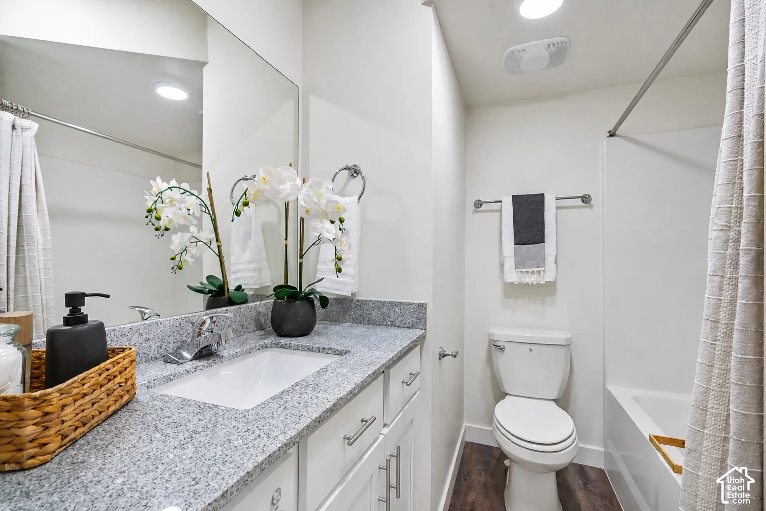 Vanity with a polished chrome faucet and an integrated rectangular sink