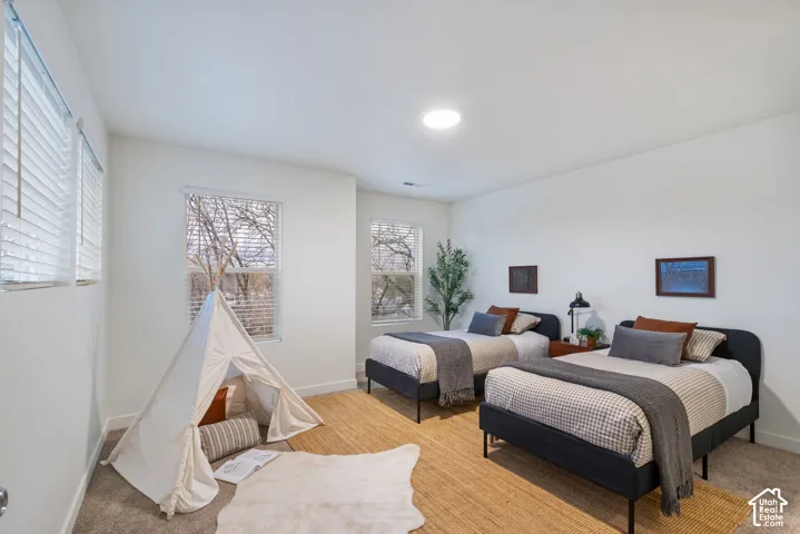 White walls, recessed lighting, and multiple windows with blinds