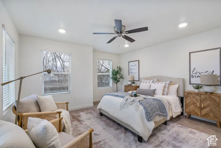 Recessed lighting, ceiling fan, and multiple windows with blinds