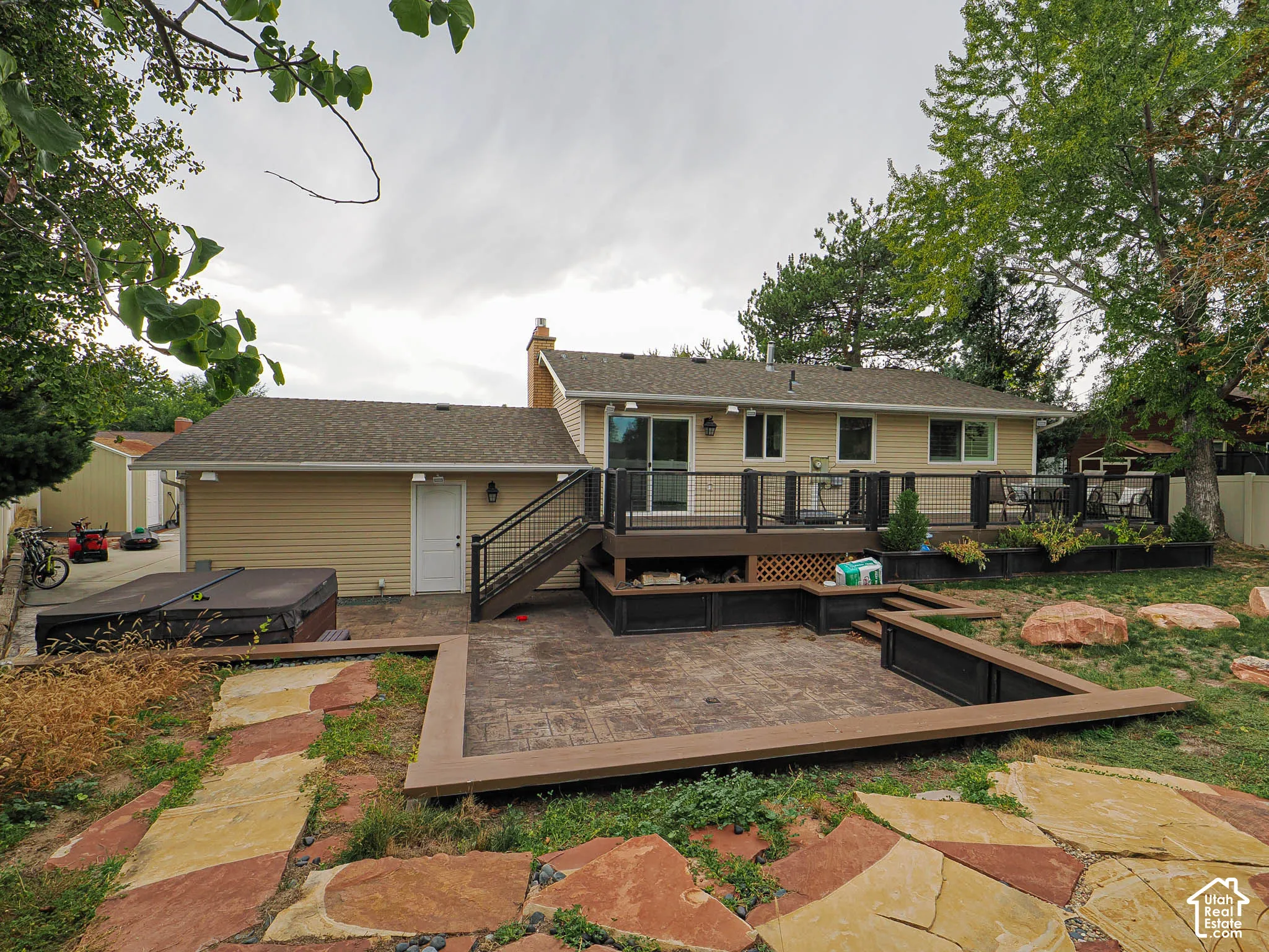 Multi-level exterior deck with dark wood-finish railing