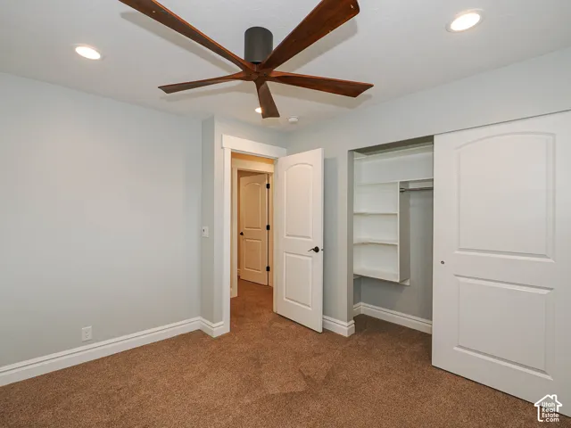 Recessed lighting, wood-finish ceiling fan, carpeted flooring, white trim, and built-in closet shelving