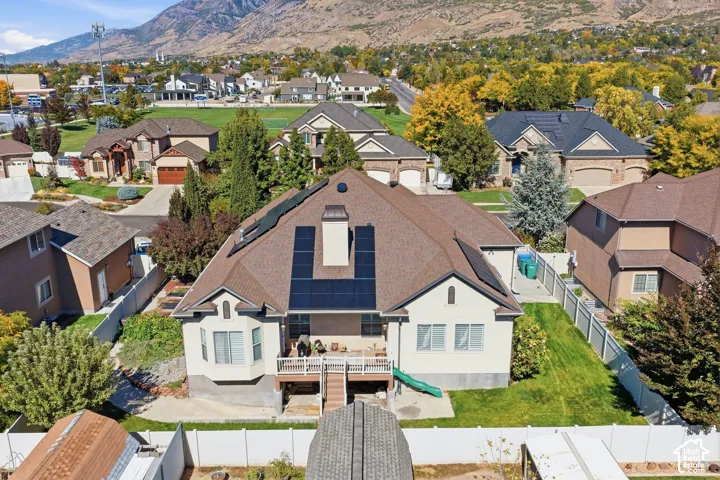 Two-story residence with a bay window, rear deck, and solar panels