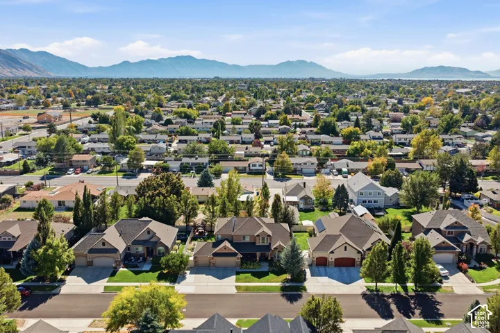 Residential neighborhood with mature trees and mountain scenery