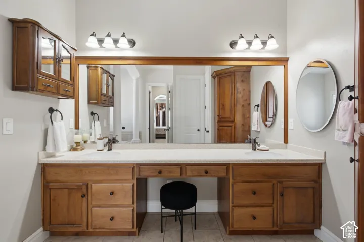 Double vanity with light-toned countertop, dual rectangular sinks, and wood-finish cabinetry