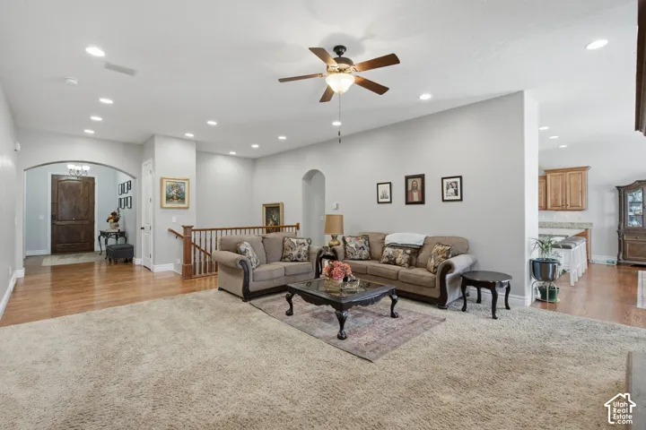 Spacious living room with soaring ceilings, recessed lighting, and ceiling fan