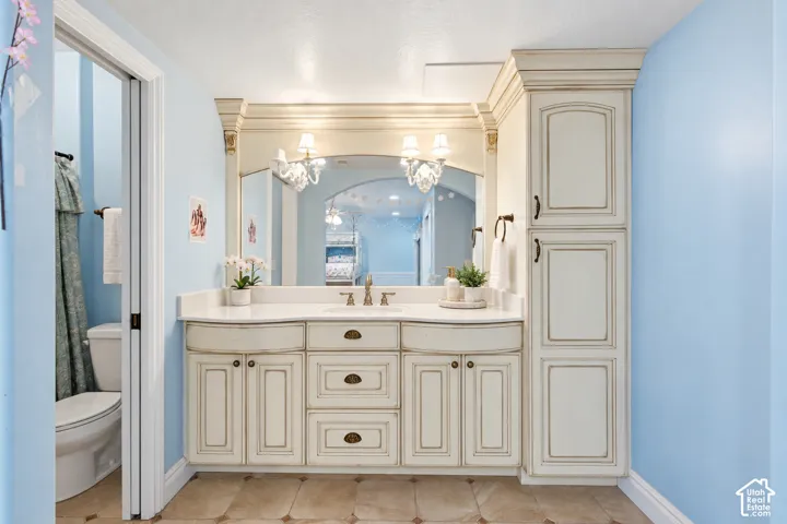 Vanity featuring an integrated sink, polished faucet, and white countertop