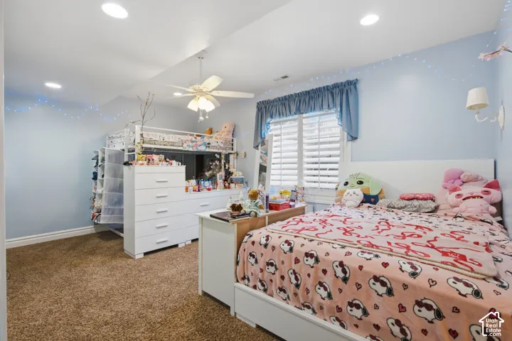 Recessed ceiling lighting, ceiling fan light fixture, window with horizontal blinds, carpeted flooring, and wall-mounted light fixture