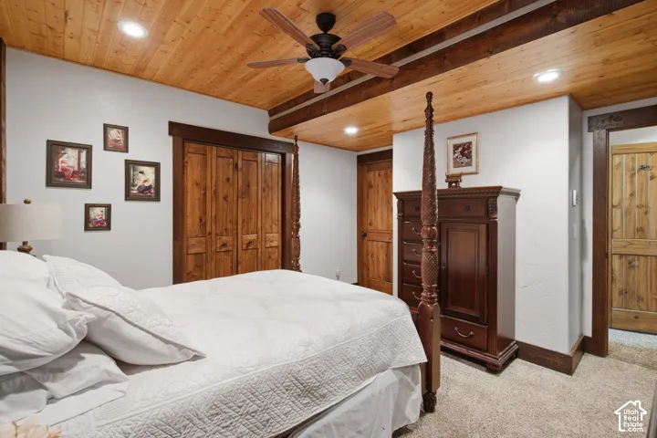 Wood-paneled ceiling with recessed lighting and exposed beams
