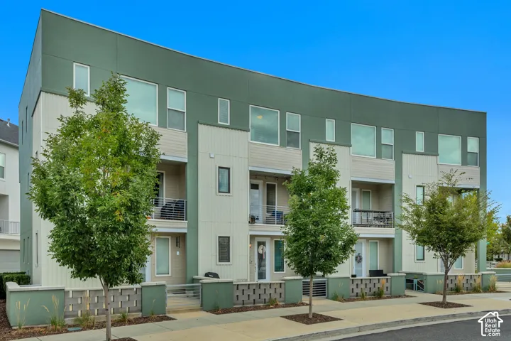Contemporary multi-story facade featuring varied siding materials and a curved architectural element