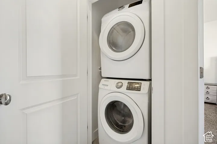 White stackable washer and dryer within an alcove