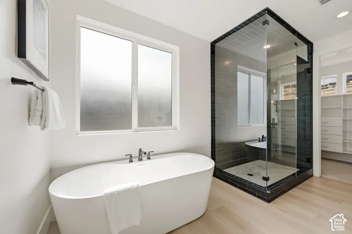 Freestanding bathtub and spacious walk in shower in the primary suite bathroom