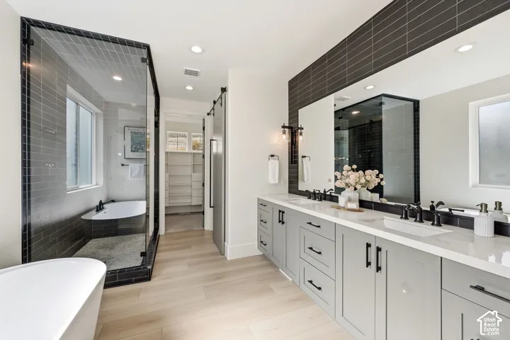 Primary suite bathroom with a double sink vanity