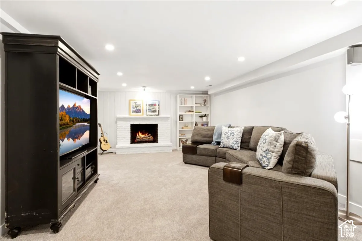 White brick fireplace with a wood mantel