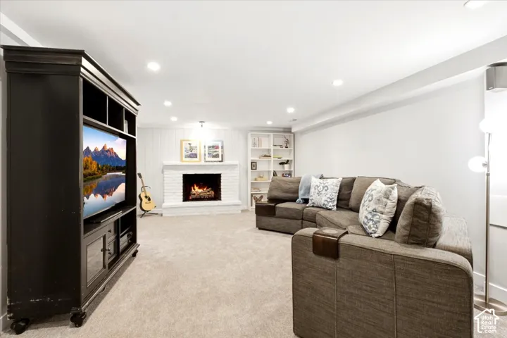 White brick fireplace with a wood mantel