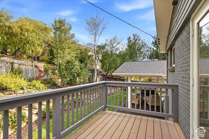 Deck with composite wood-finish flooring and a painted wood railing