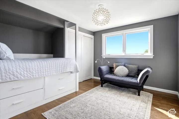 Hardwood-finish flooring, built-in storage drawers, white trim, and a contemporary ceiling light fixture