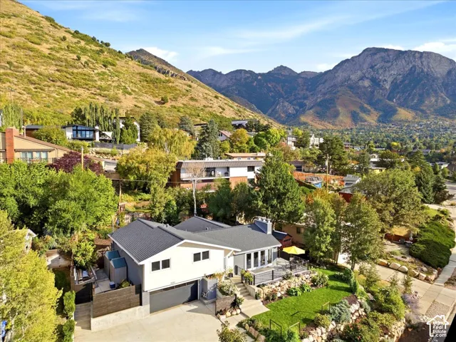 Property with a contemporary exterior, multiple decks, and a landscaped front yard with stone retaining walls