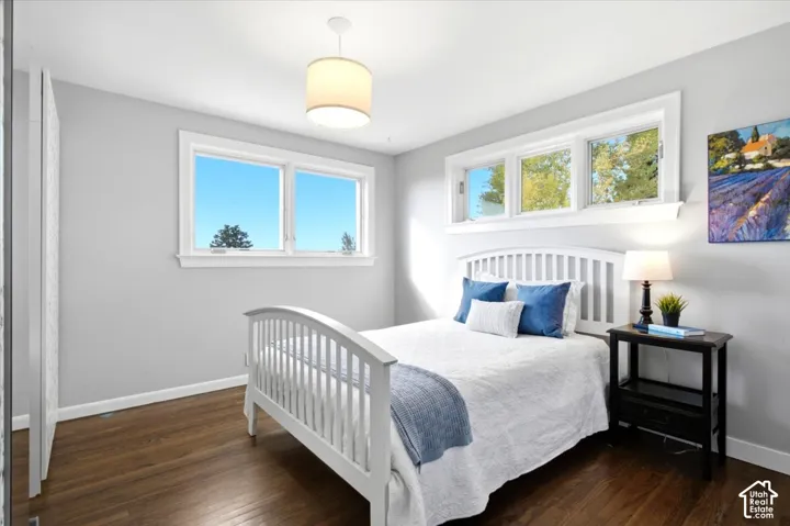 Hardwood flooring, multiple large windows, and a ceiling-mounted light fixture