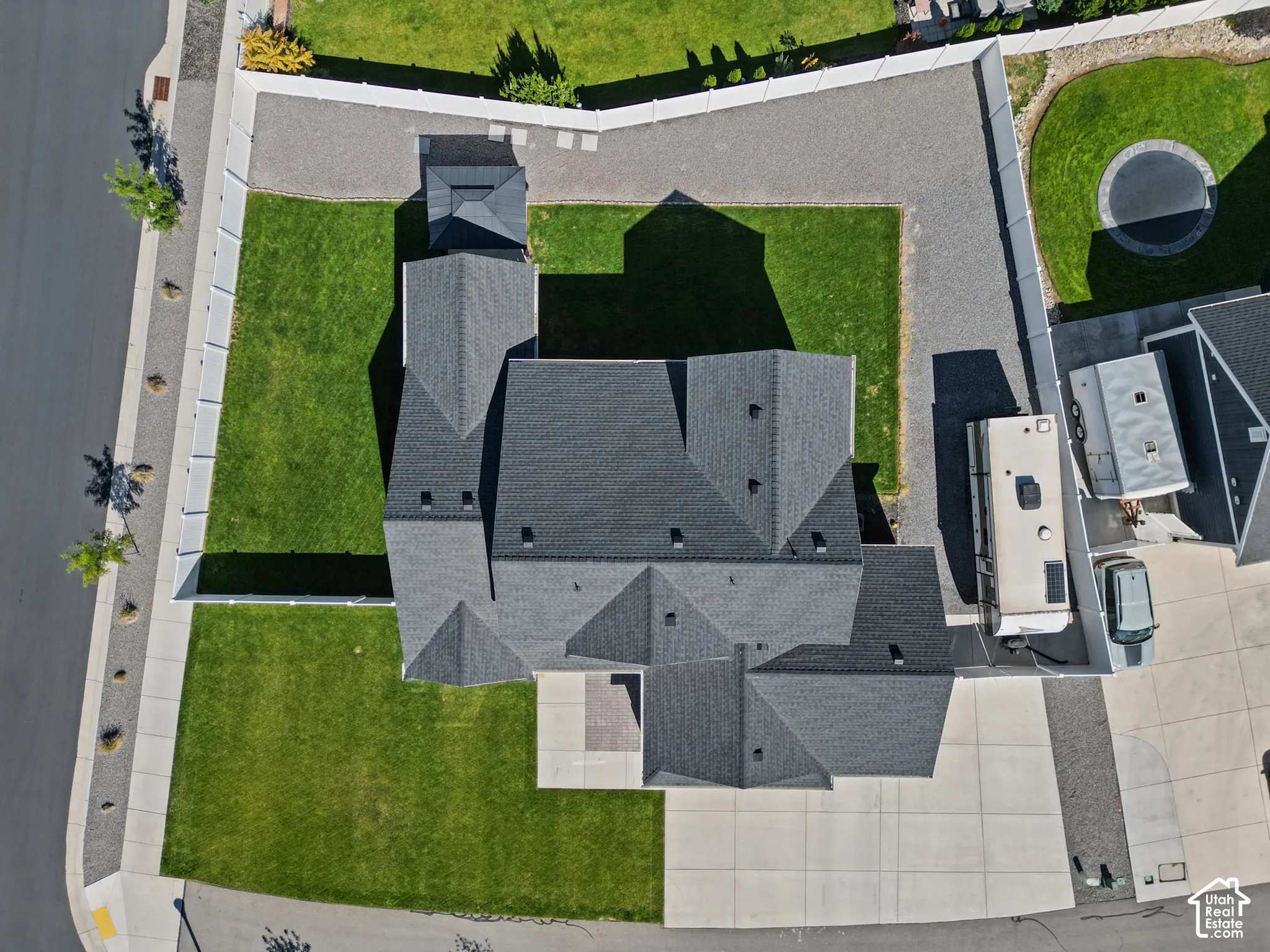 Expansive lot featuring a large lawn, dedicated RV parking area, and a paved driveway