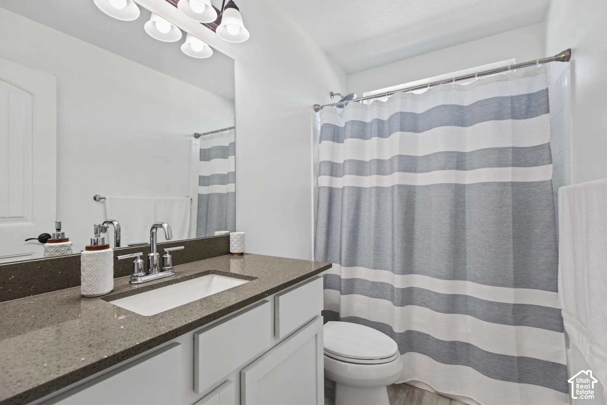 Vanity with an integrated rectangular sink, chrome faucet, and substantial mirror