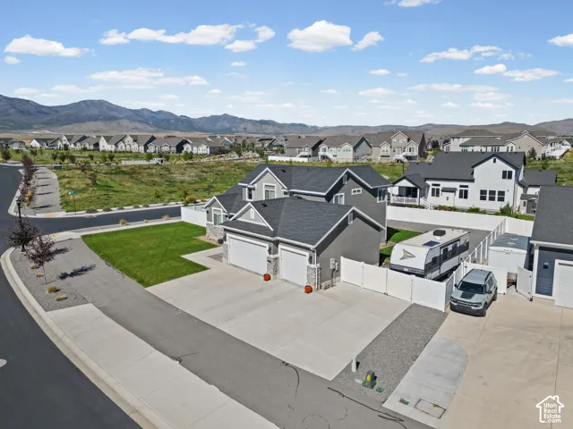 Multi-level exterior with gray siding and stone accents
