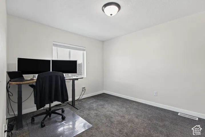 Neutral wall tones, recessed window, and textured carpeting