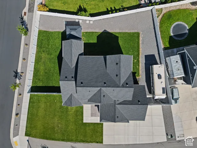 Expansive lot featuring a large lawn, dedicated RV parking area, and a paved driveway