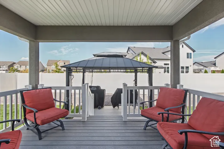 Covered outdoor patio featuring composite decking and white railing