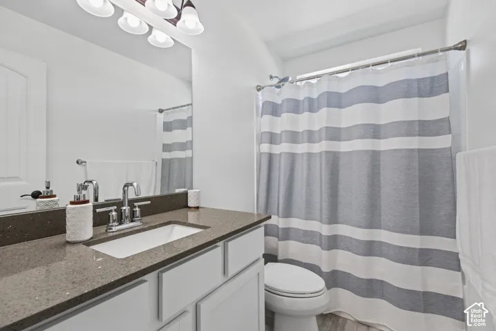 Vanity with an integrated rectangular sink, chrome faucet, and substantial mirror