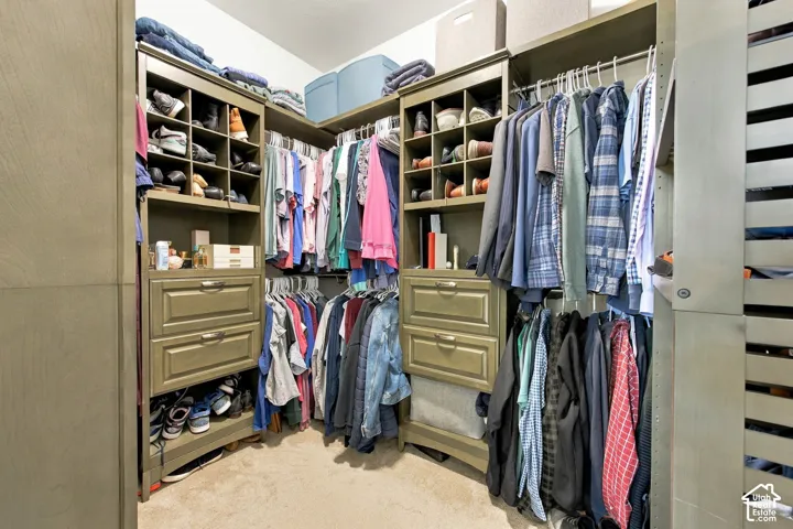 Primary - Built-in closet system featuring shelving, drawers, and hanging rods
