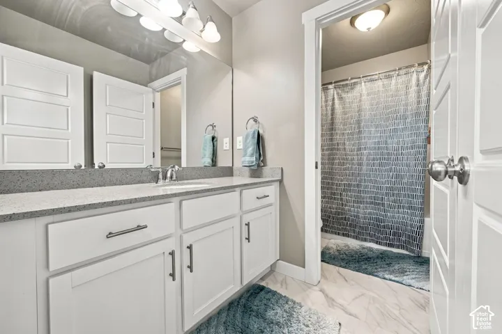 Dual vanity with a stone countertop and integrated sink